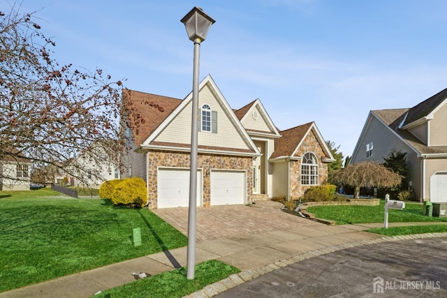 view of front of house with a garage and a front yard