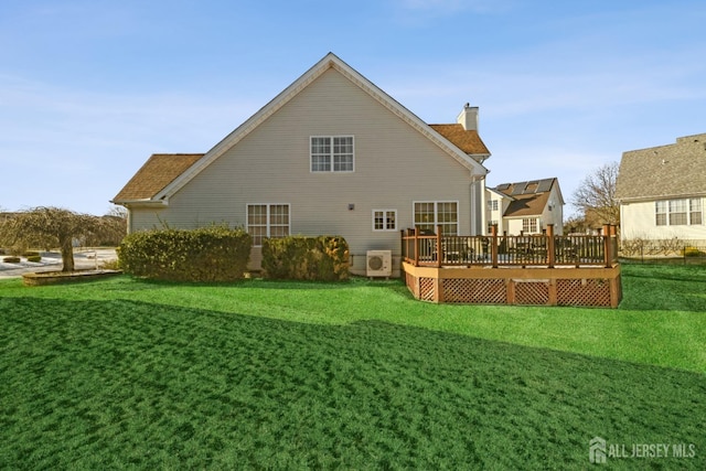 back of property with a wooden deck, ac unit, and a lawn