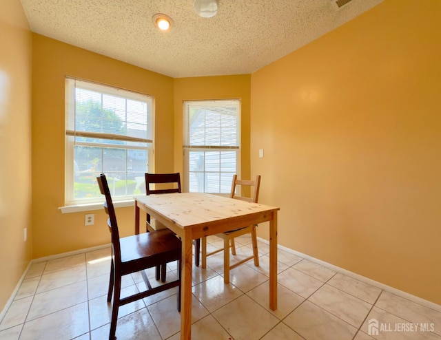 67 Nova Dr, Piscataway, NJ 08854 - dining space with a textured ceiling, baseboards, and light tile patterned floors