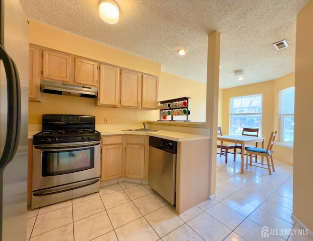 67 Nova Dr, Piscataway, NJ 08854 - kitchen featuring appliances with stainless steel finishes, under cabinet range hood, light brown cabinets, a textured ceiling, and light tile patterned flooring