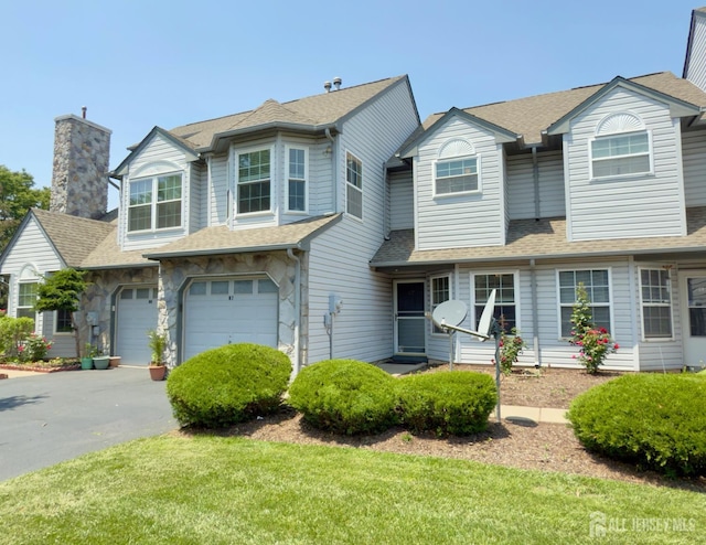 67 Nova Dr, Piscataway, NJ 08854 - multi unit property featuring a garage, roof with shingles, asphalt driveway, a chimney, and a front yard