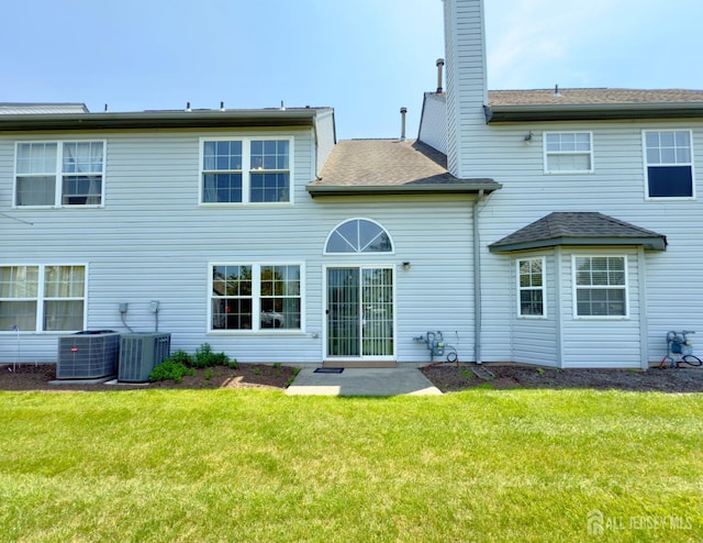 67 Nova Dr, Piscataway, NJ 08854 - back of house featuring central air condition unit, a yard, roof with shingles, and a chimney