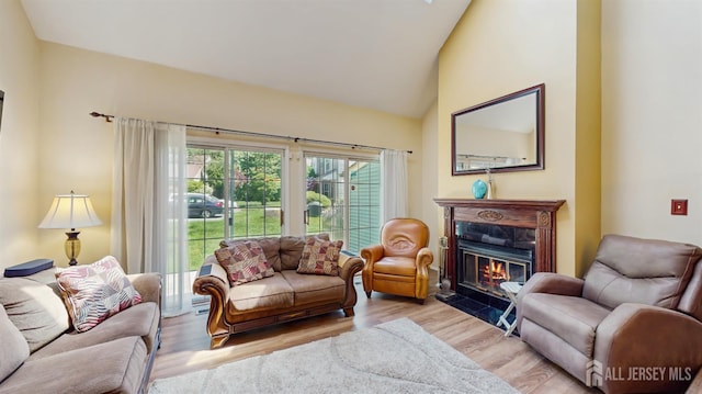 1014 Hemlock Ct, South Brunswick, NJ 08852 - living area featuring wood finished floors, a tile fireplace, and vaulted ceiling
