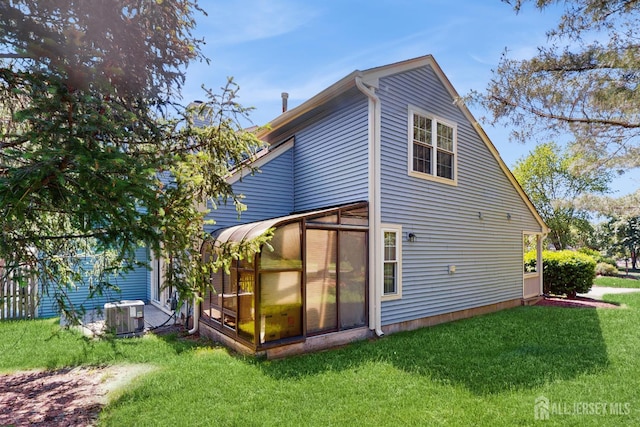 1014 Hemlock Ct, South Brunswick, NJ 08852 - back of house featuring central AC, a sunroom, and a lawn