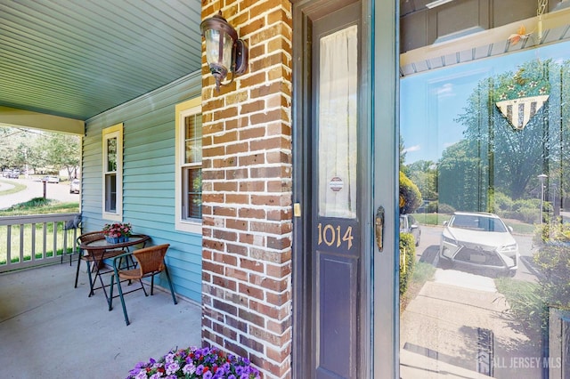 1014 Hemlock Ct, South Brunswick, NJ 08852 - view of exterior entry featuring covered porch and brick siding