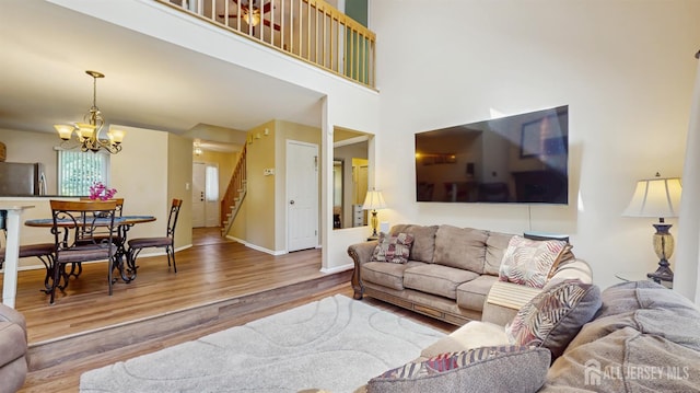 1014 Hemlock Ct, South Brunswick, NJ 08852 - living area featuring wood finished floors, stairs, a chandelier, baseboards, and a towering ceiling
