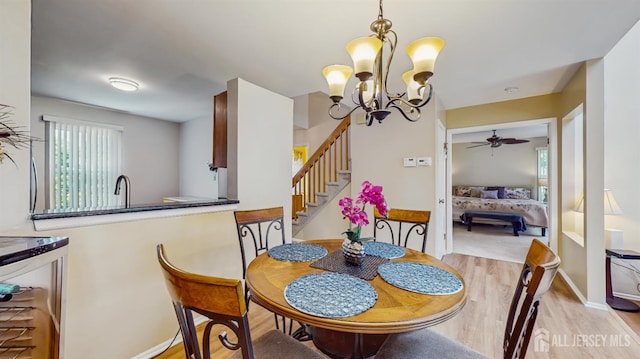 1014 Hemlock Ct, South Brunswick, NJ 08852 - dining room featuring wood finished floors, stairs, a chandelier, a ceiling fan, and baseboards