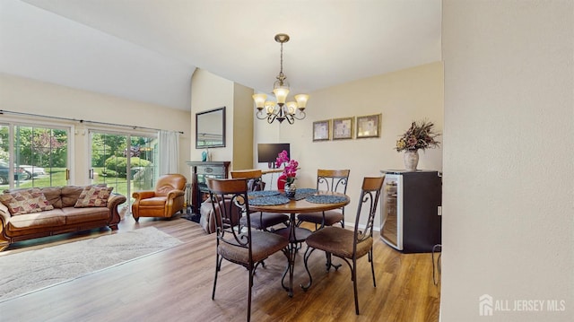 1014 Hemlock Ct, South Brunswick, NJ 08852 - dining area featuring a chandelier, light wood-type flooring, and lofted ceiling