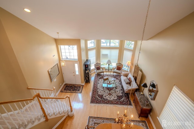 9 Copernicus Ct, East Windsor, NJ 08512 - living area with wood finished floors, a towering ceiling, recessed lighting, a chandelier, and stairway