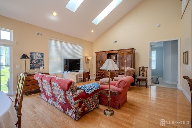 9 Copernicus Ct, East Windsor, NJ 08512 - living area with high vaulted ceiling, a skylight, light wood finished floors, and recessed lighting