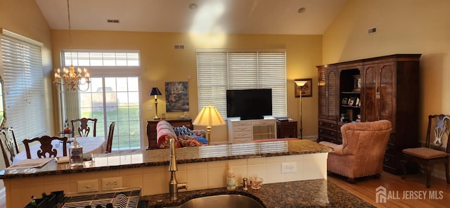 9 Copernicus Ct, East Windsor, NJ 08512 - living room featuring wood finished floors, a chandelier, and high vaulted ceiling