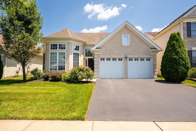 9 Copernicus Ct, East Windsor, NJ 08512 - traditional-style home featuring asphalt driveway, a garage, a front yard, and roof with shingles