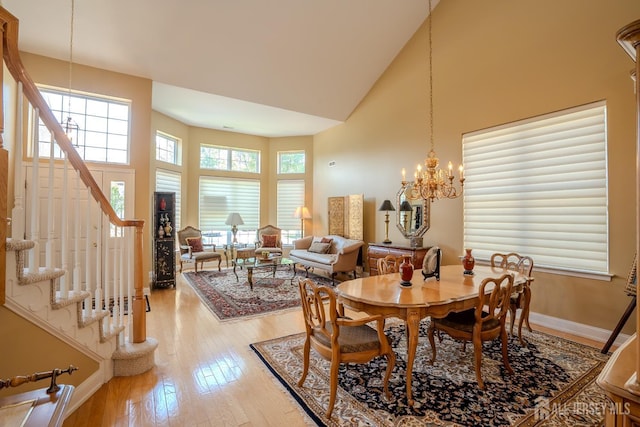 9 Copernicus Ct, East Windsor, NJ 08512 - dining area featuring high vaulted ceiling, light wood-style floors, stairs, and a chandelier