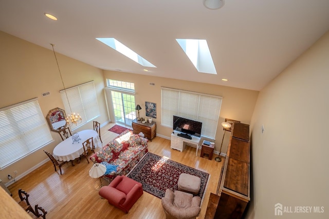 9 Copernicus Ct, East Windsor, NJ 08512 - living area with a skylight, vaulted ceiling, wood finished floors, and recessed lighting