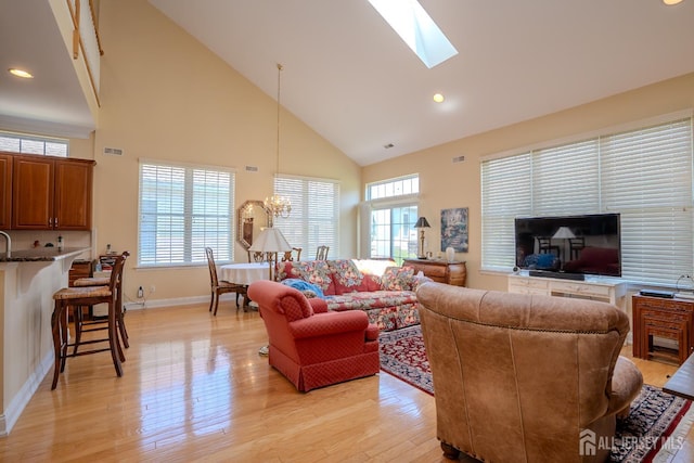 9 Copernicus Ct, East Windsor, NJ 08512 - living room featuring high vaulted ceiling, light wood-style floors, a skylight, a chandelier, and recessed lighting