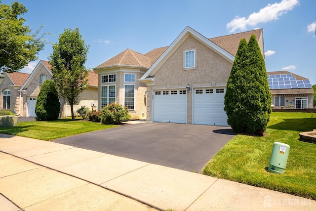 9 Copernicus Ct, East Windsor, NJ 08512 - traditional-style home featuring asphalt driveway, a garage, a front yard, and a shingled roof