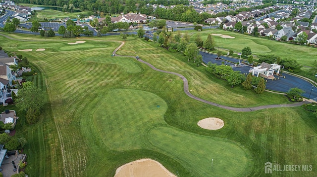 aerial overview of property's location with a local golf course and nearby suburban area