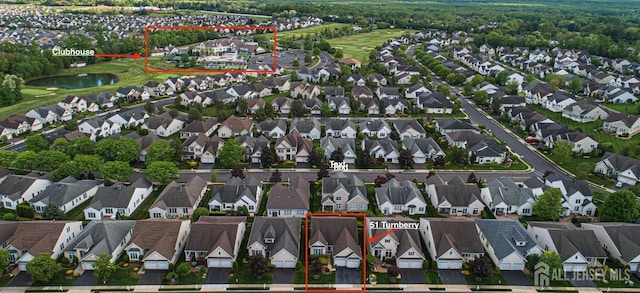 aerial perspective of suburban area featuring property parcel outlined and a nearby body of water