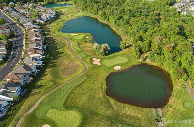 aerial view of property and surrounding area with nearby suburban area, a nearby body of water, and a golf course