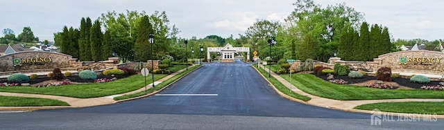 view of asphalt road with curbs and sidewalks