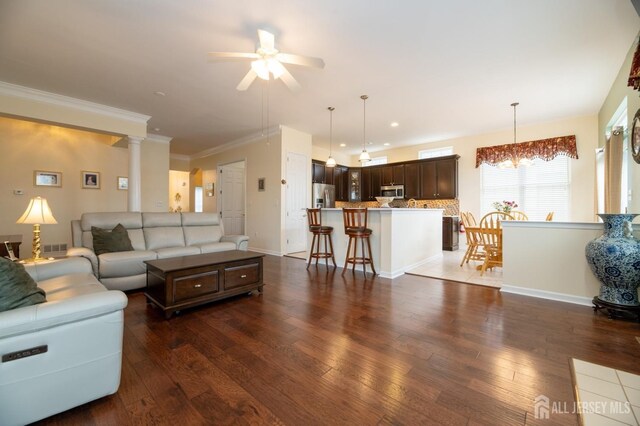 living room with ceiling fan, hardwood / wood-style flooring, recessed lighting, and ornamental molding