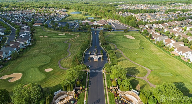 aerial overview of property's location featuring a large body of water, nearby suburban area, and a golf course