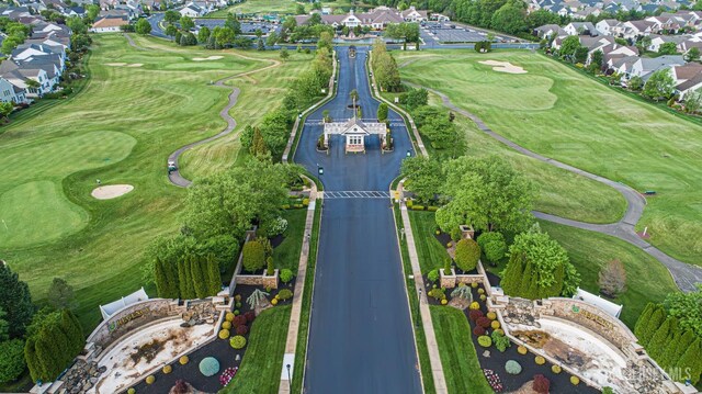 aerial view of property and surrounding area with nearby suburban area and a local golf course