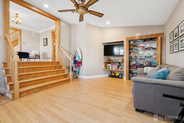 living area with stairs, wood finished floors, a ceiling fan, baseboards, and recessed lighting