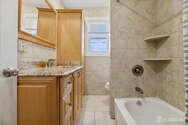 bathroom featuring vanity, toilet, tile patterned flooring, and shower / bath combination