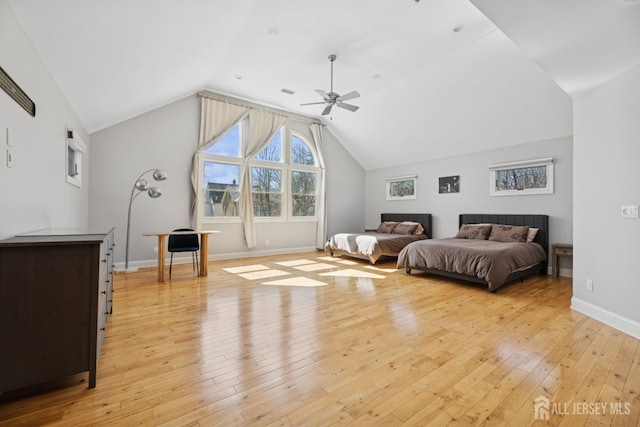 bedroom featuring lofted ceiling, light wood-style floors, baseboards, and ceiling fan