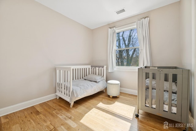 bedroom with baseboards and wood finished floors