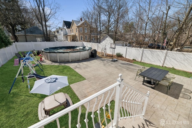 view of yard with a patio area, outdoor dining area, and a playground