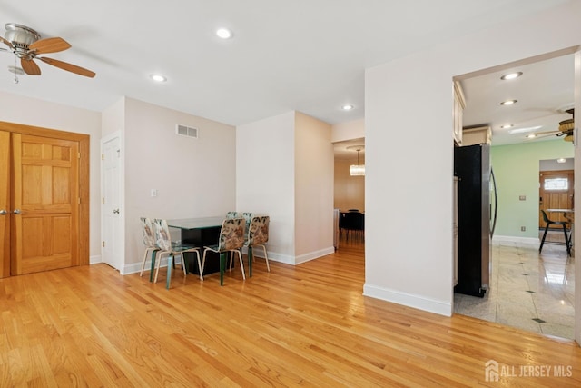 dining space featuring ceiling fan, light wood finished floors, baseboards, and recessed lighting
