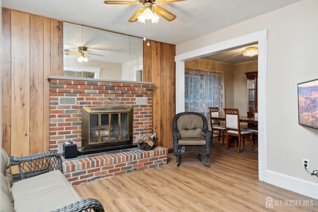 113 Coleman St, Middlesex, NJ 08846 - living area featuring ceiling fan, a fireplace, wood finished floors, baseboards, and wooden walls