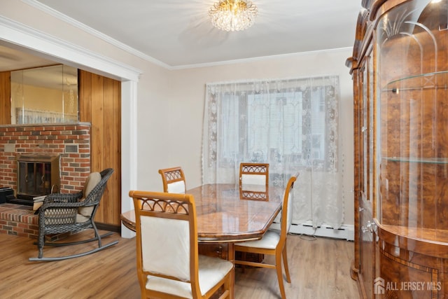 113 Coleman St, Middlesex, NJ 08846 - dining space with a baseboard radiator, wood finished floors, a brick fireplace, crown molding, and a chandelier