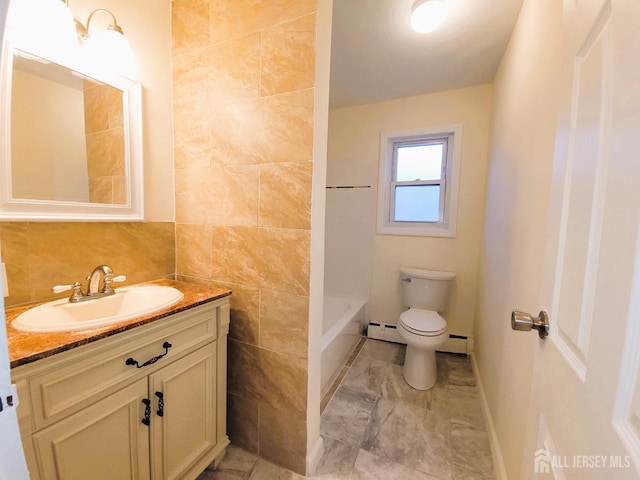 full bath featuring baseboard heating, tile walls, vanity, and toilet