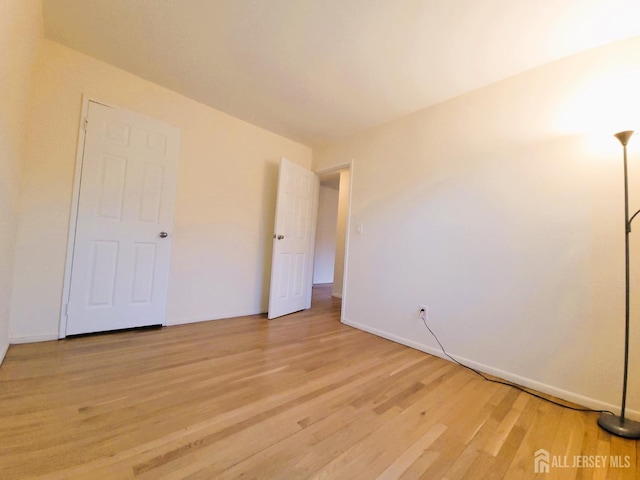 unfurnished bedroom featuring baseboards and light wood-style floors