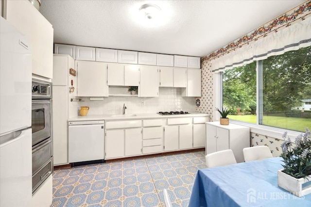 29 Mitchell Ave, Piscataway, NJ 08854 - kitchen with white appliances, light countertops, white cabinetry, open shelves, and decorative backsplash