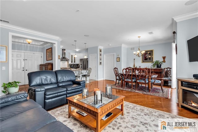 1109 Enclave Cir, Franklin, NJ 08873 - living area with crown molding, a notable chandelier, visible vents, and light wood-type flooring