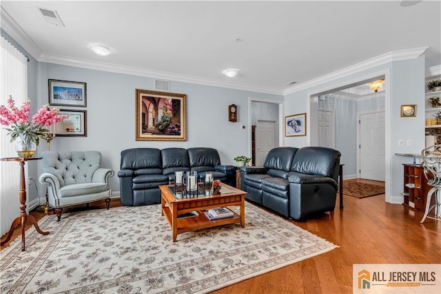 living room featuring crown molding and hardwood / wood-style floors