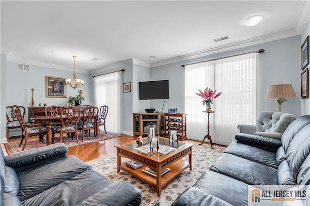 1109 Enclave Cir, Franklin, NJ 08873 - living area featuring an inviting chandelier, light wood finished floors, crown molding, and visible vents
