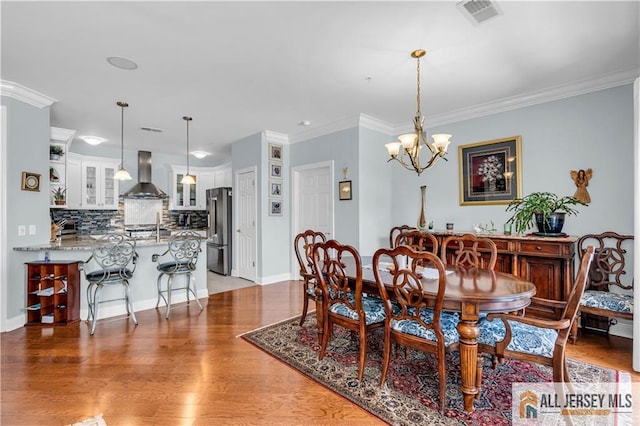1109 Enclave Cir, Franklin, NJ 08873 - dining area with ornamental molding, a notable chandelier, light wood finished floors, and visible vents