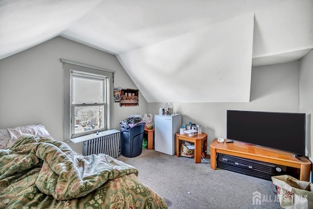 bedroom featuring lofted ceiling, carpet, refrigerator, and radiator