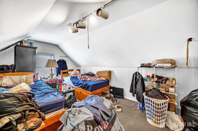 bedroom featuring lofted ceiling, track lighting, and carpet floors