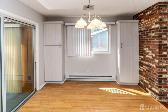 249 Doremus Dr Unit B, Monroe, NJ 08831 - unfurnished dining area with a baseboard radiator, a chandelier, and light wood finished floors