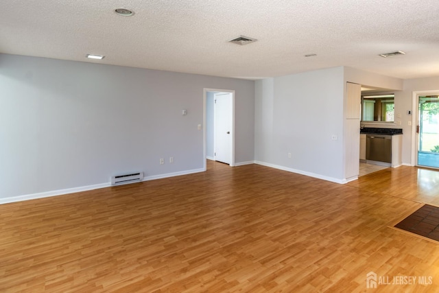 249 Doremus Dr Unit B, Monroe, NJ 08831 - empty room with light wood-style flooring, a textured ceiling, baseboards, and baseboard heating