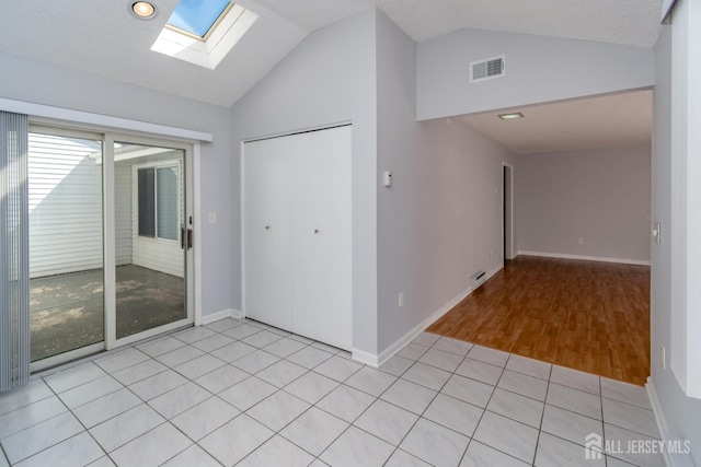 249 Doremus Dr Unit B, Monroe, NJ 08831 - foyer with lofted ceiling, a skylight, baseboards, and light wood-style flooring