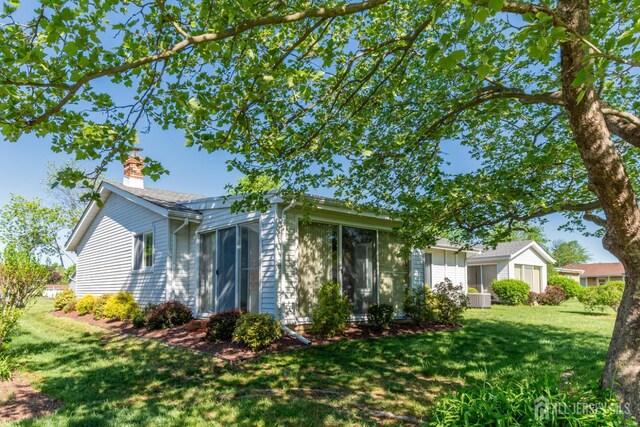 249 Doremus Dr Unit B, Monroe, NJ 08831 - view of front of property featuring a sunroom, a chimney, and a front yard