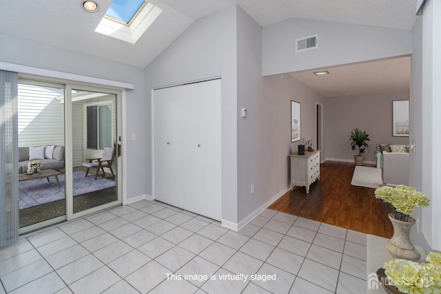 249 Doremus Dr Unit B, Monroe, NJ 08831 - foyer featuring vaulted ceiling, a skylight, baseboards, and light tile patterned flooring