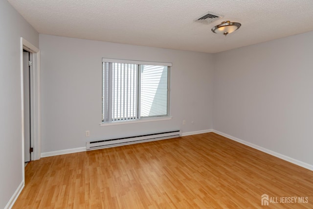 249 Doremus Dr Unit B, Monroe, NJ 08831 - empty room with a baseboard radiator, light wood-type flooring, baseboards, and a textured ceiling
